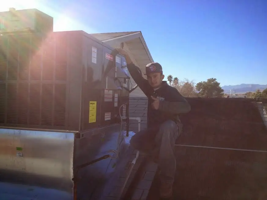 HVAC technician performing HVAC Inspection on a rooftop unit in Berwick